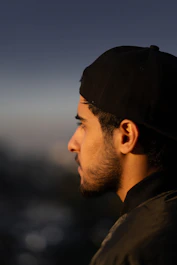 a man with a beard and a black hat