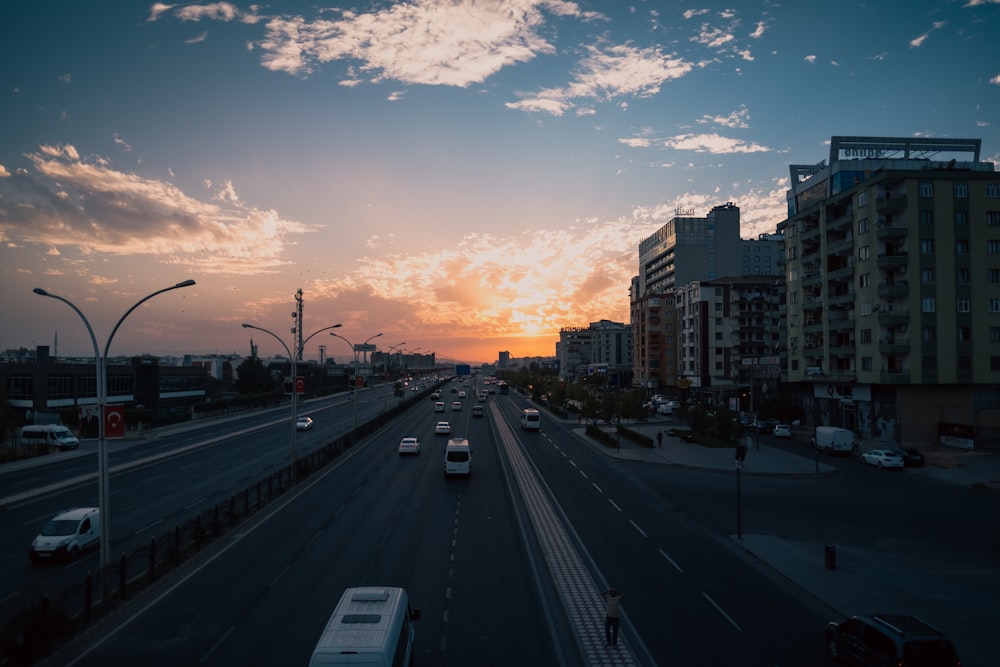 the sun is setting over a city street