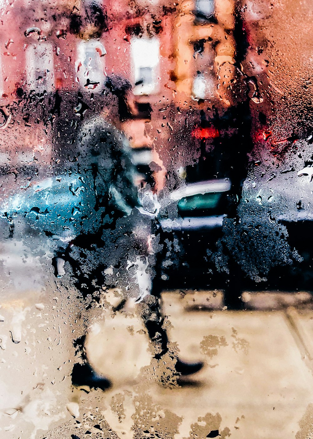 a person walking down a street holding an umbrella