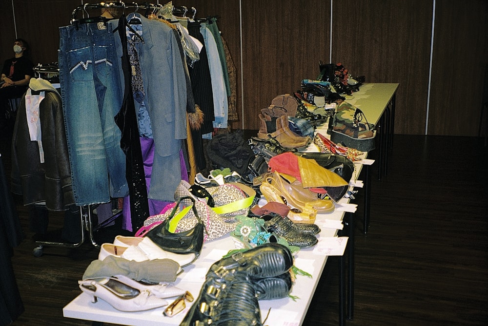 a table with many pairs of shoes on it