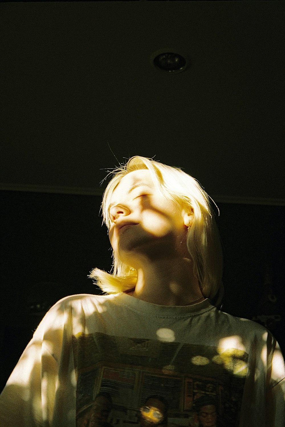 a woman with blonde hair is looking up into the sky