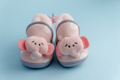 A cozy pair of baby booties in soft pastel colors.