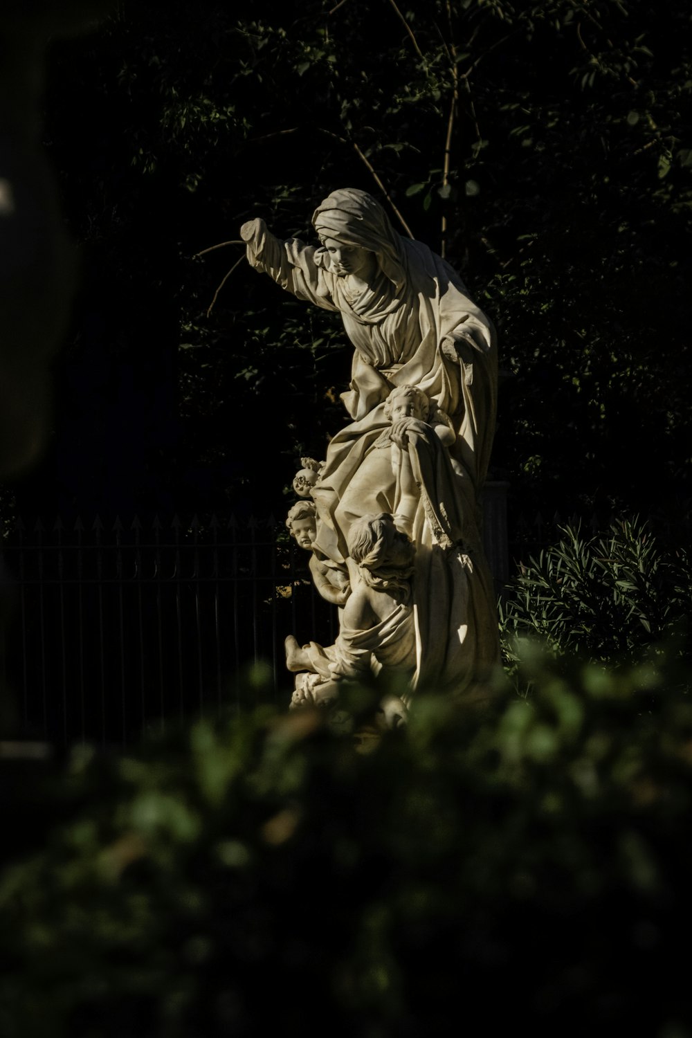 a statue of a man holding a stick