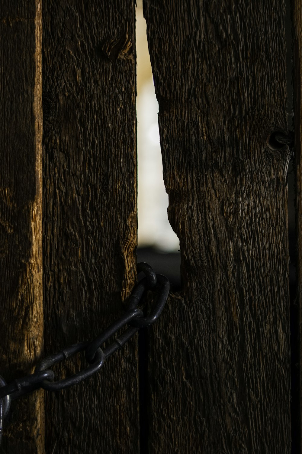 a close up of a chain attached to a wooden door