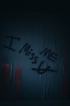 graffiti writing on a wall in a dark room