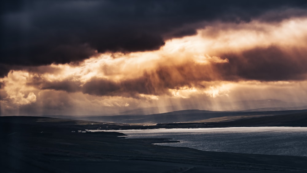 a large body of water under a cloudy sky