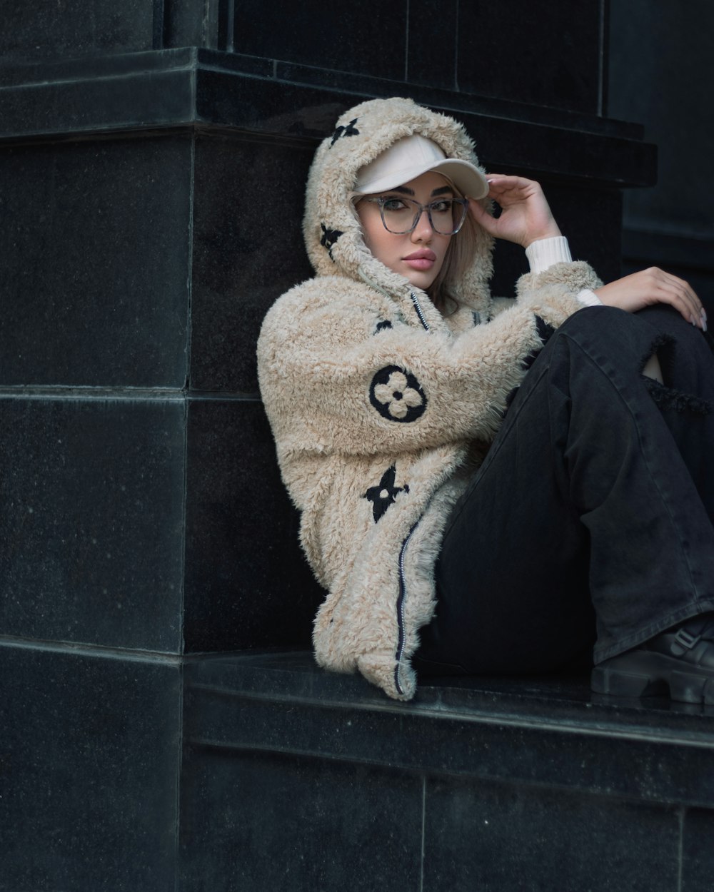 a woman sitting on a ledge wearing a teddy bear costume
