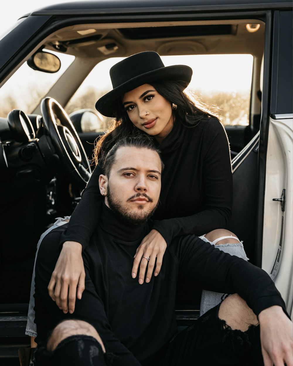 a man and a woman sitting in the back of a truck