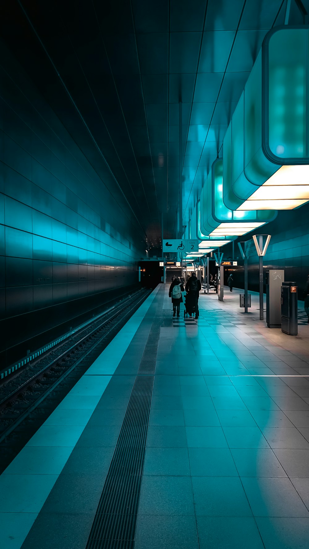 a train station with people walking on the platform