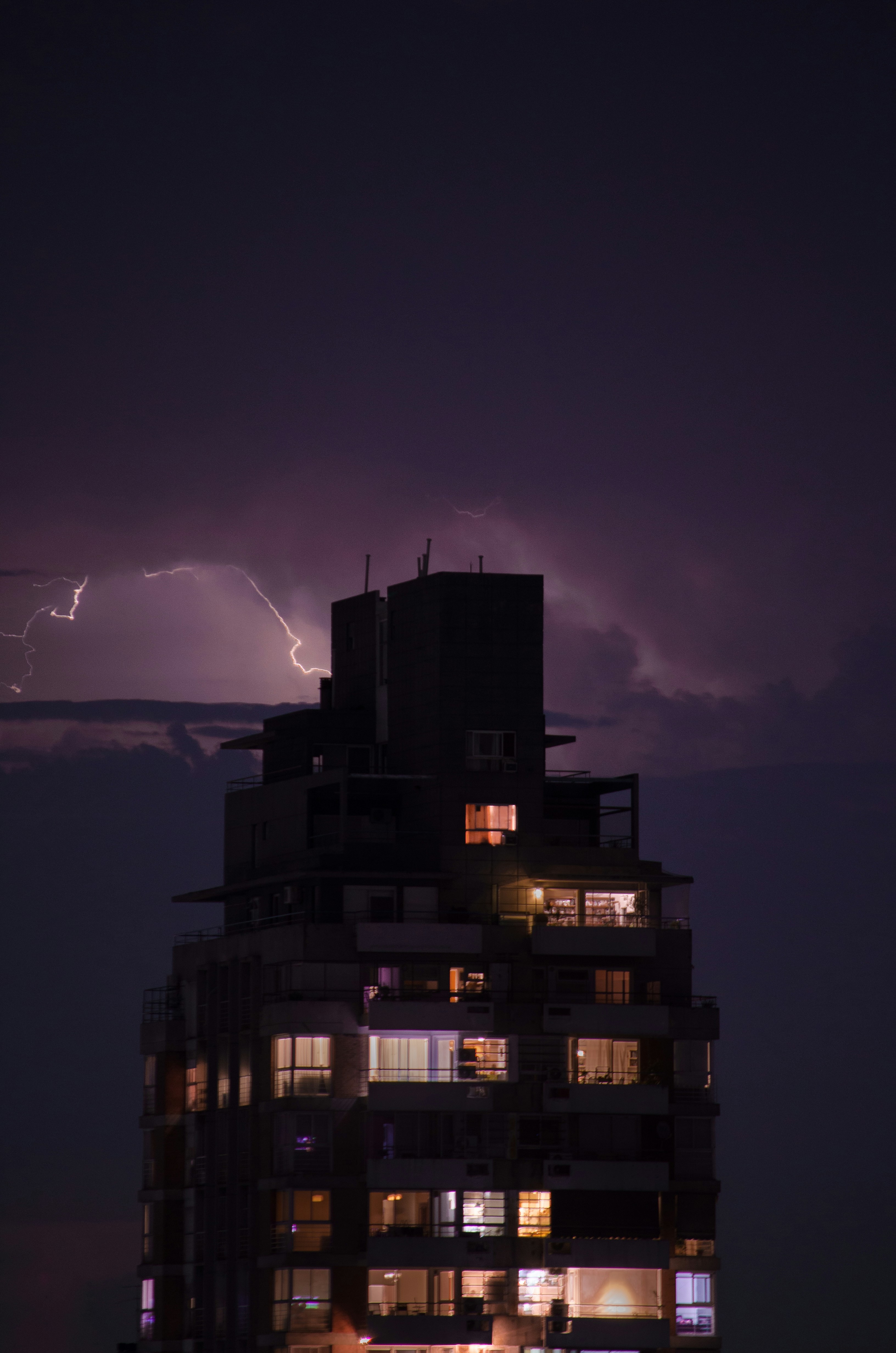 A building with a lightning bolt in the background photo – Free ...
