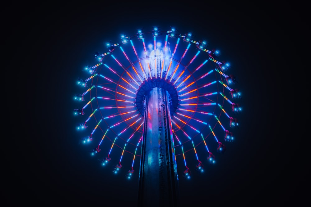 a ferris wheel lit up in the night sky