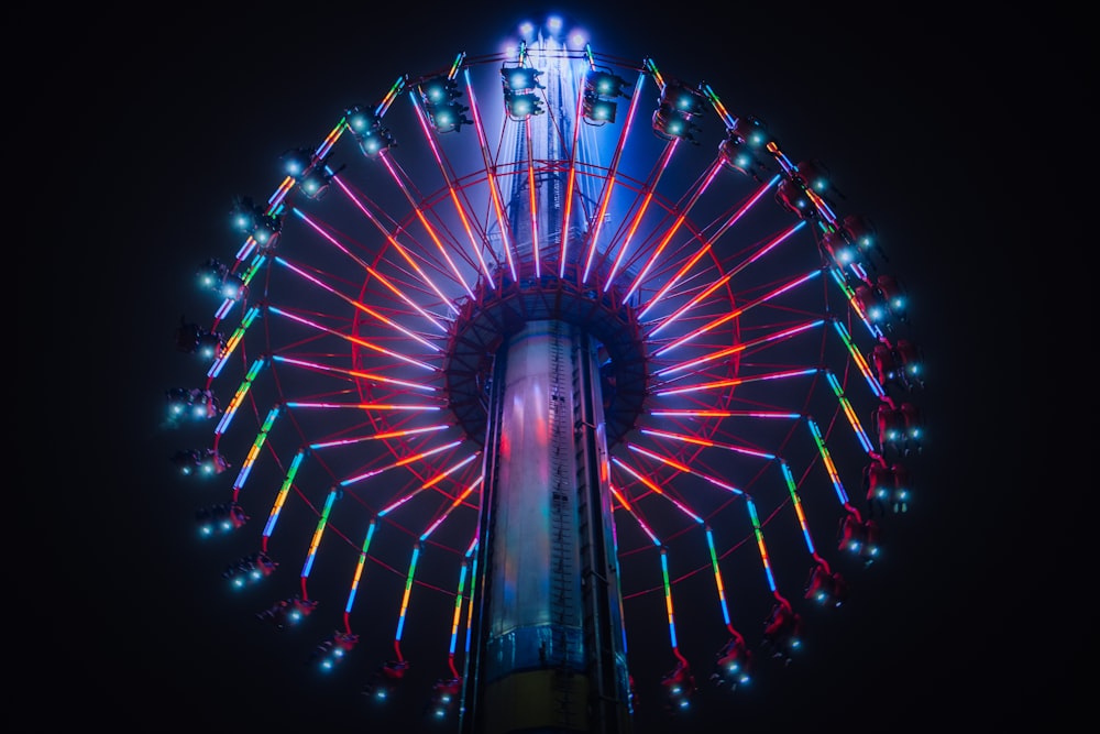 a large ferris wheel lit up at night