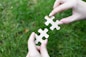 a person holding a piece of a puzzle in their hands