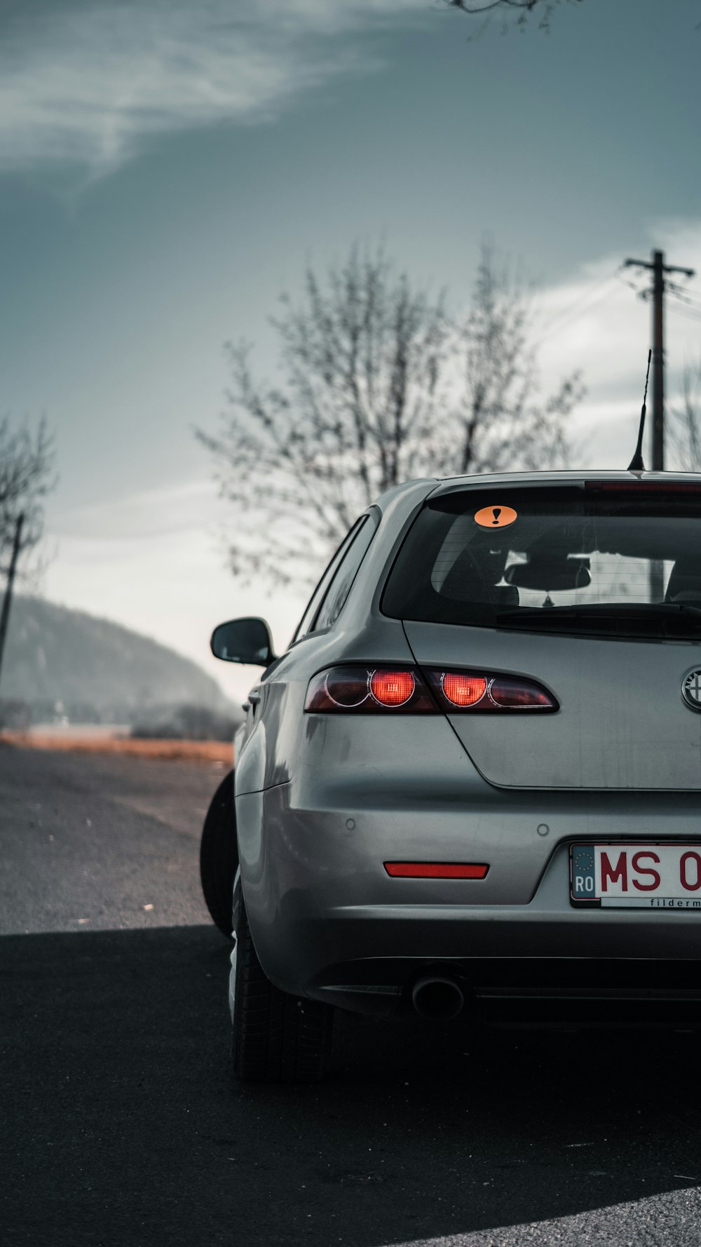 a silver car parked on the side of the road