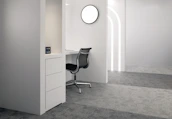 A tidy, minimalist office space with black furniture and subtle pink accents, freshly cleaned.