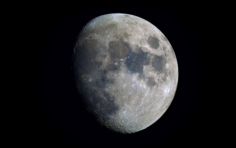 a full moon is shown in the dark sky