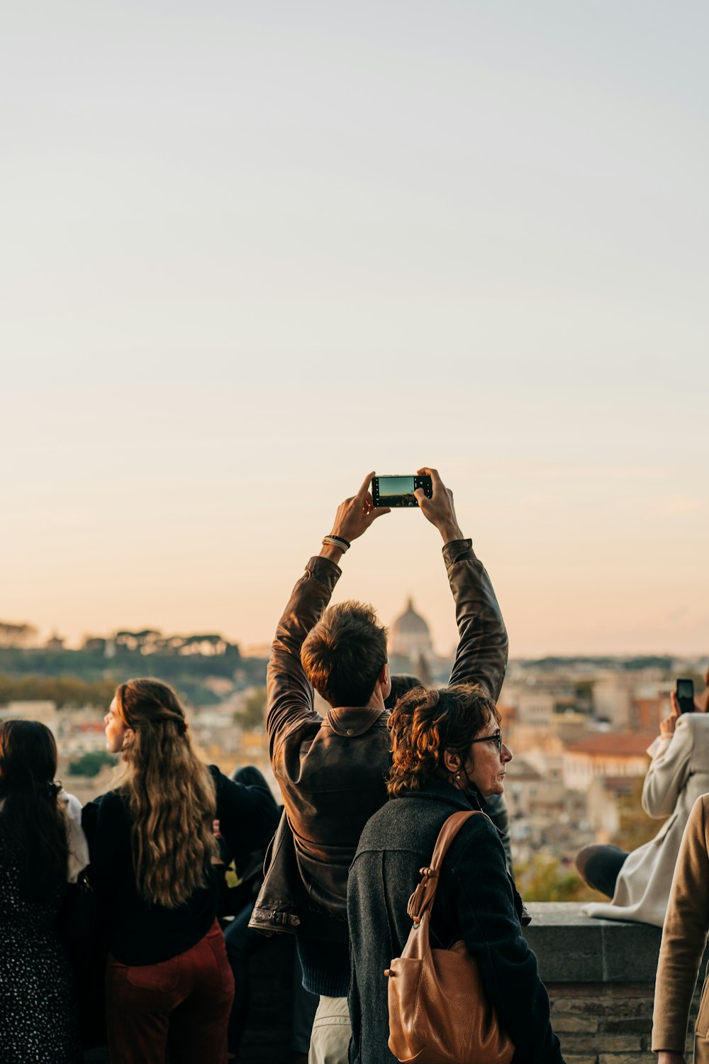 a group of people taking pictures with their cell phones