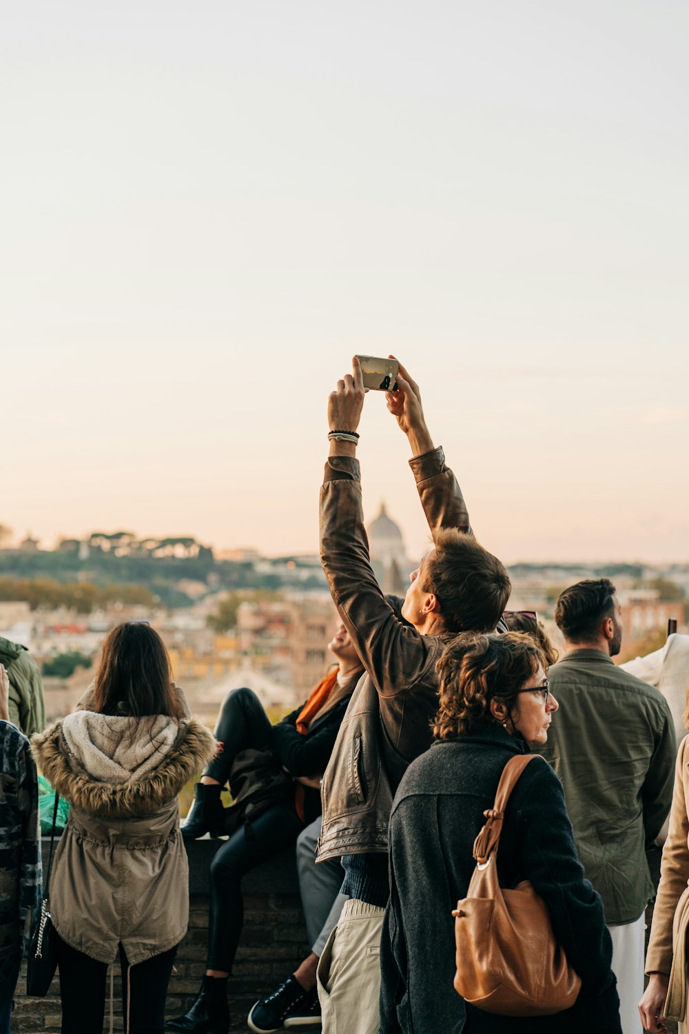 a group of people taking pictures with their cell phones