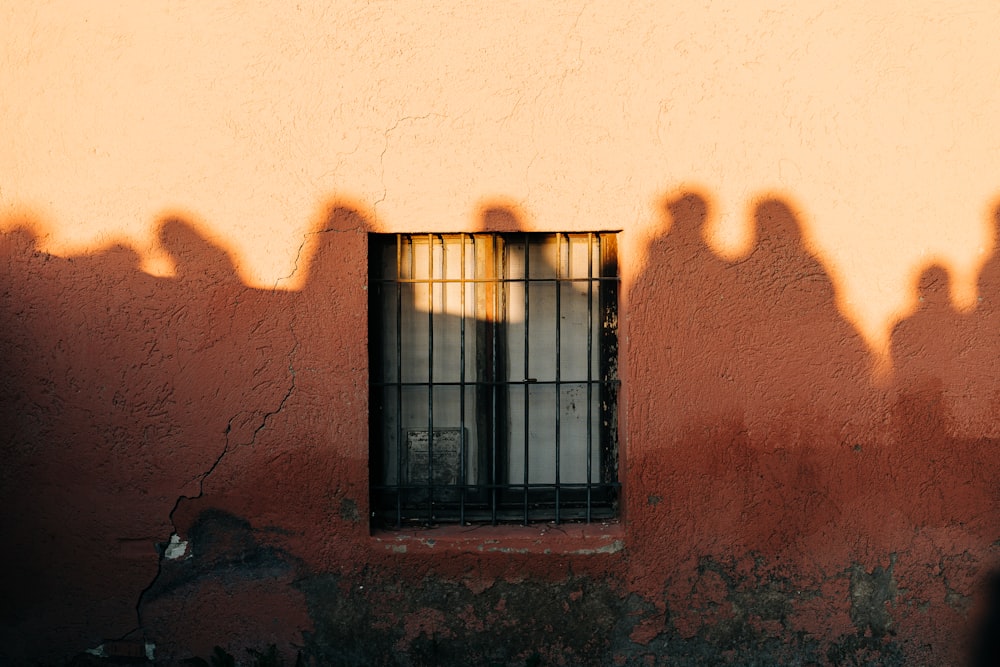 a group of people standing in front of a window