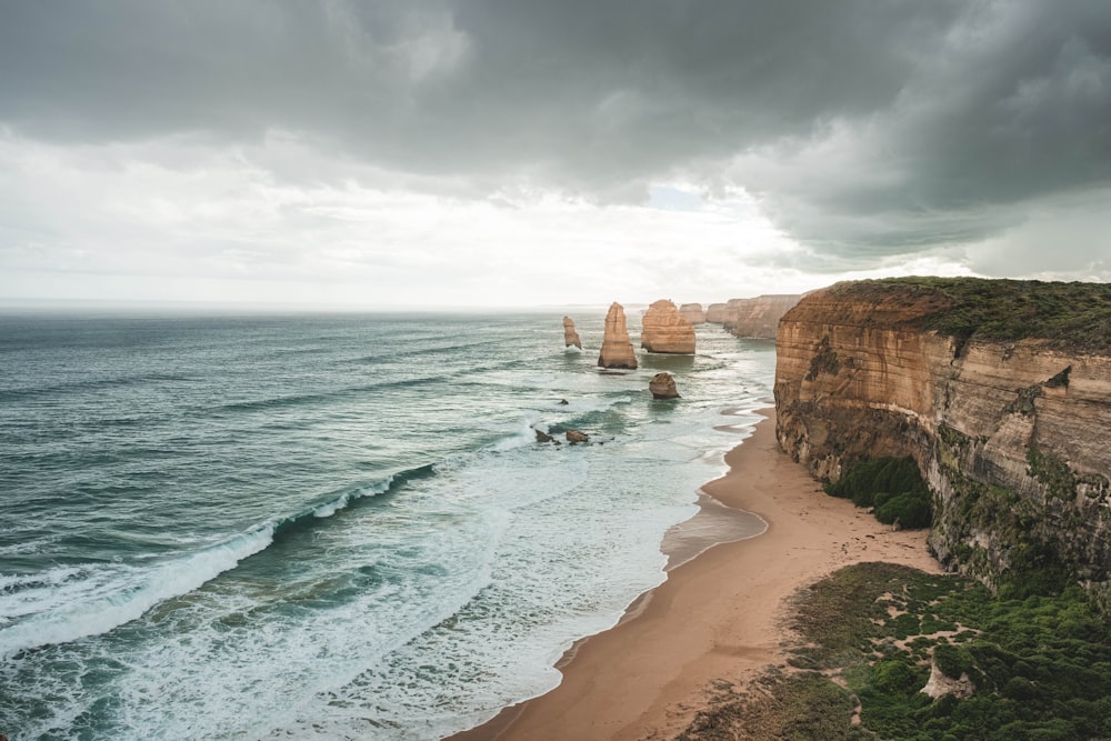 a view of the ocean and the cliffs of the great ocean road