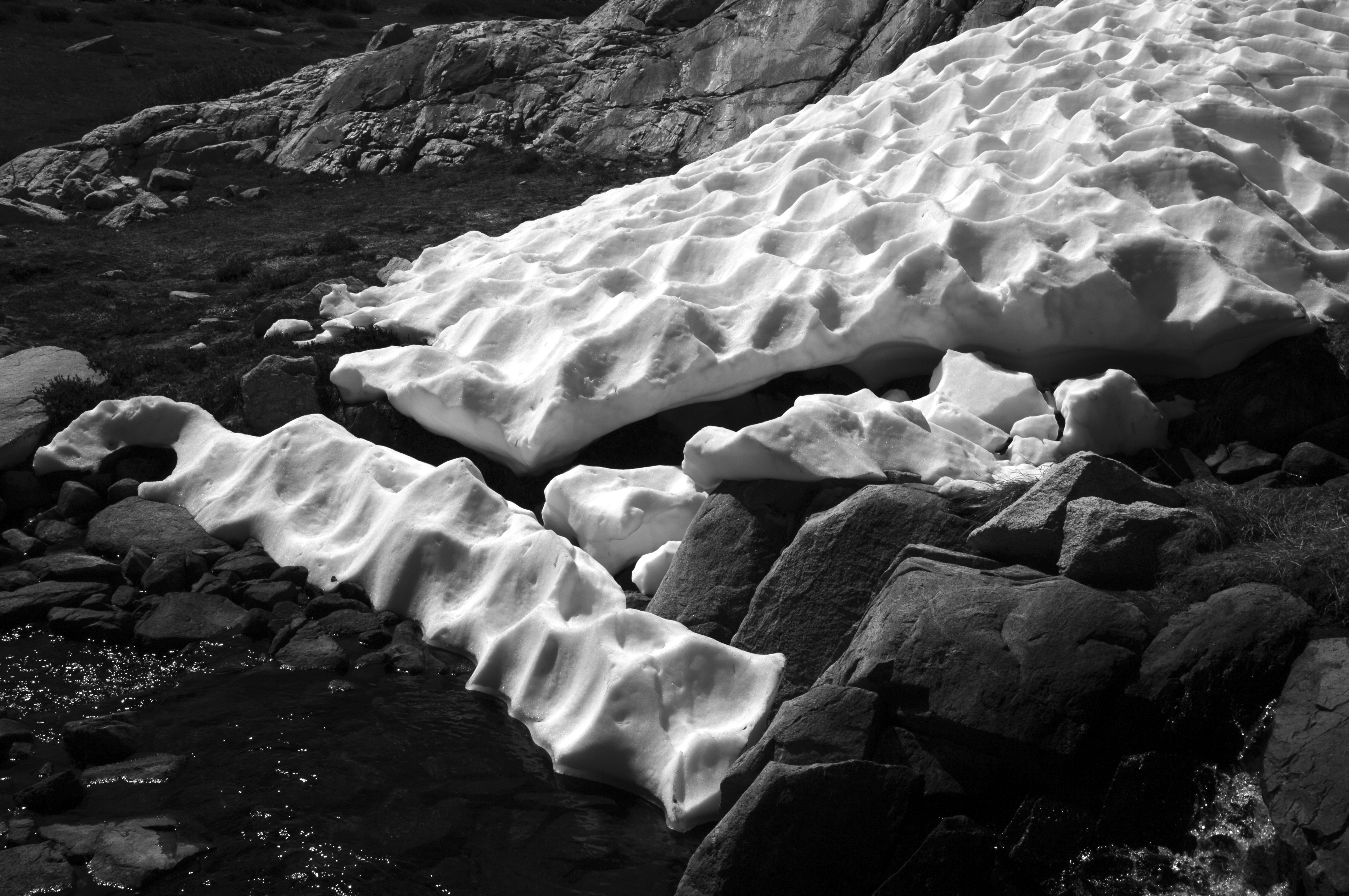a stream of water running through a rocky area