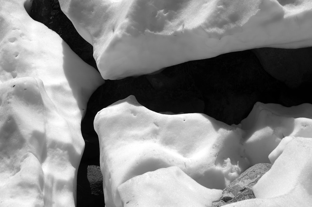 a black and white photo of snow and rocks