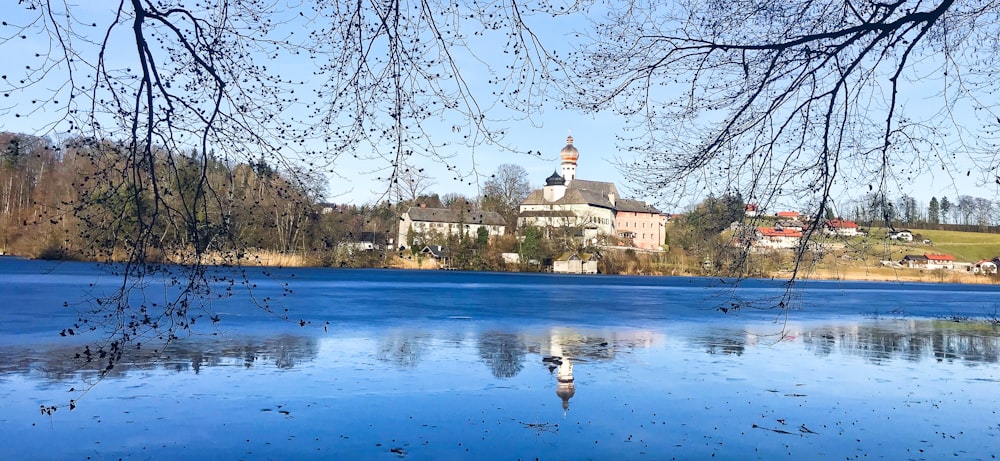a large body of water with a church in the background