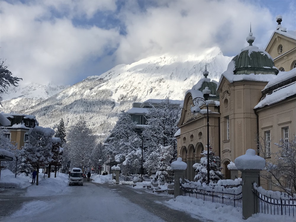 a snow covered street with a mountain in the background
