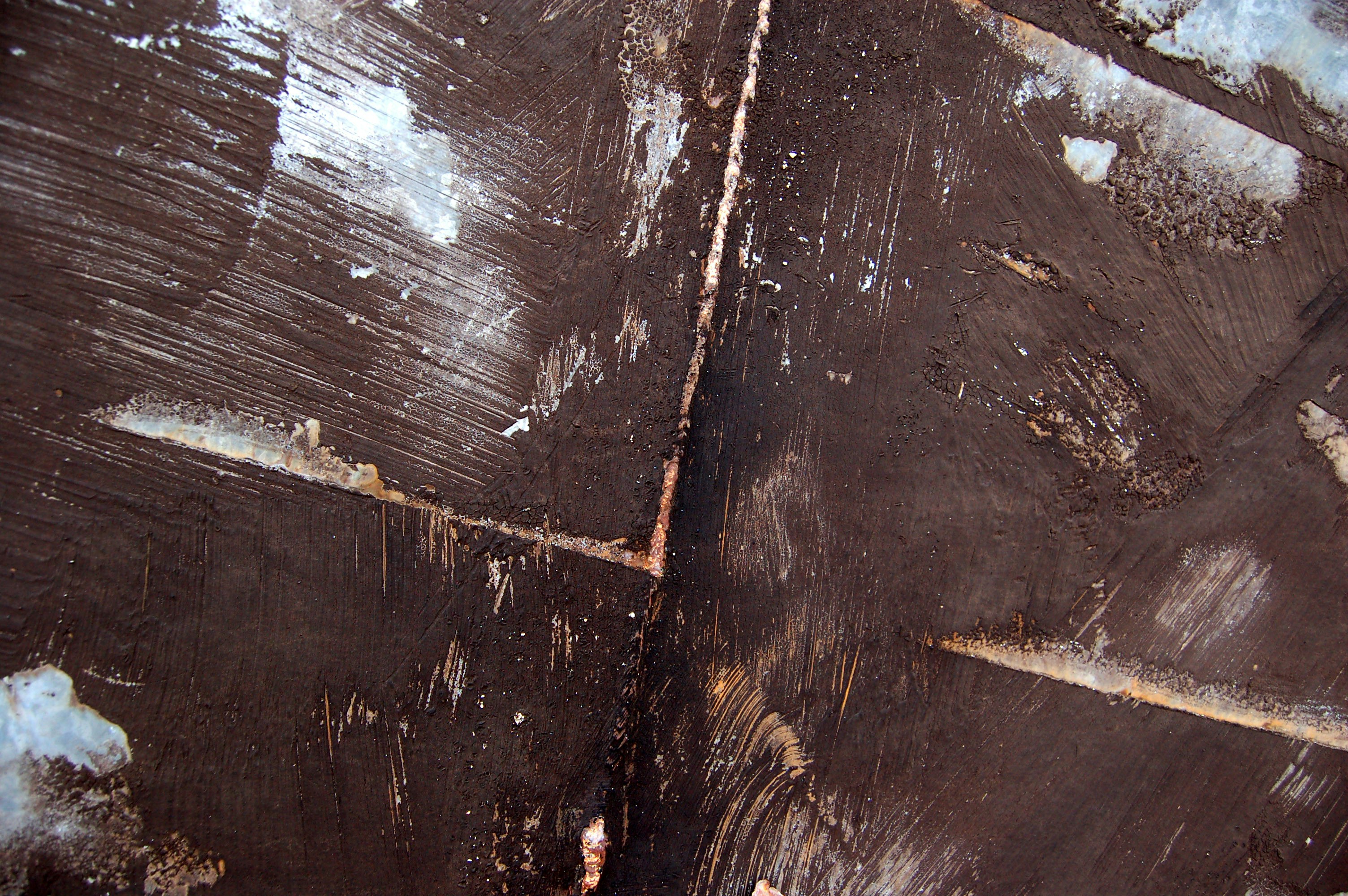 a close up of a piece of wood with peeling paint