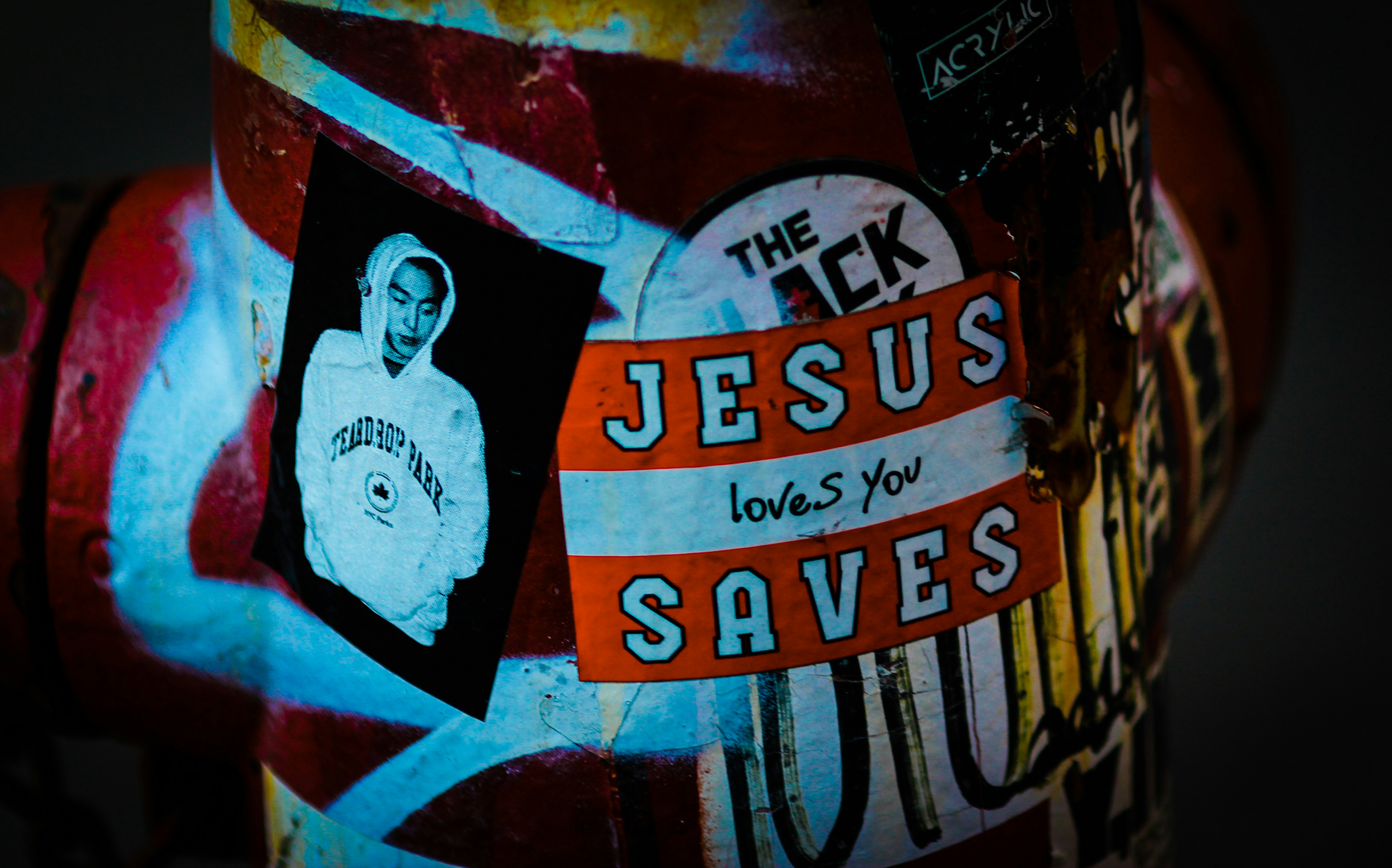 a fire hydrant with a picture of jesus painted on it