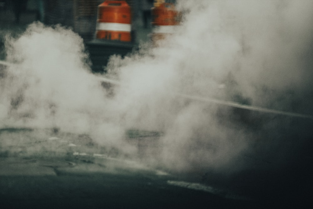 a street scene with smoke coming out of the ground