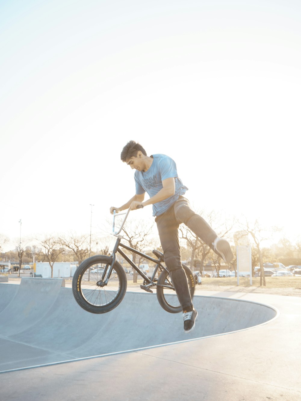 a man riding a bike up the side of a ramp