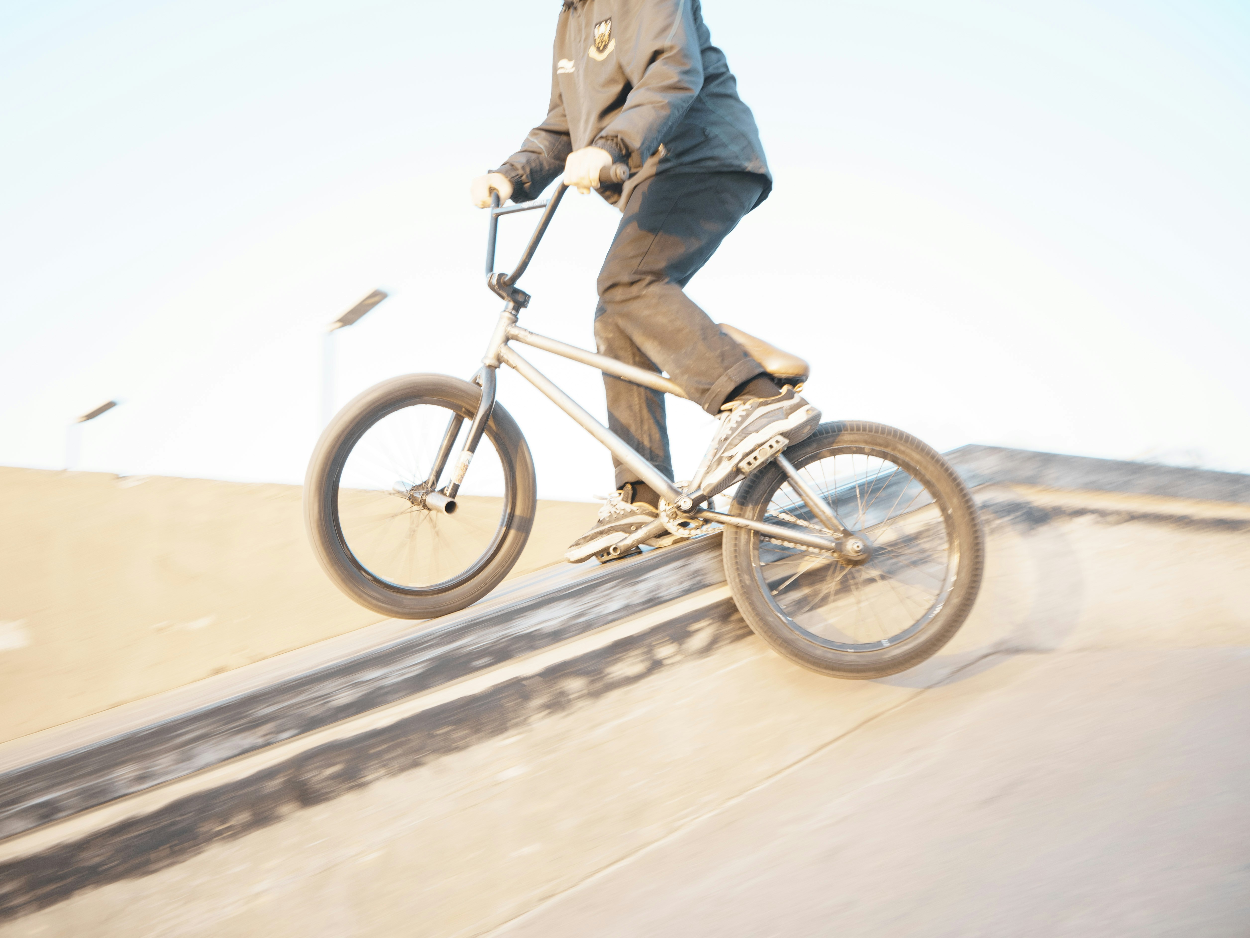 a man riding a bike down the side of a ramp