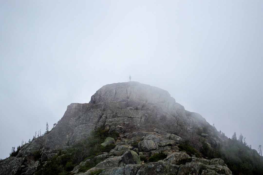 a person standing on top of a rocky mountain