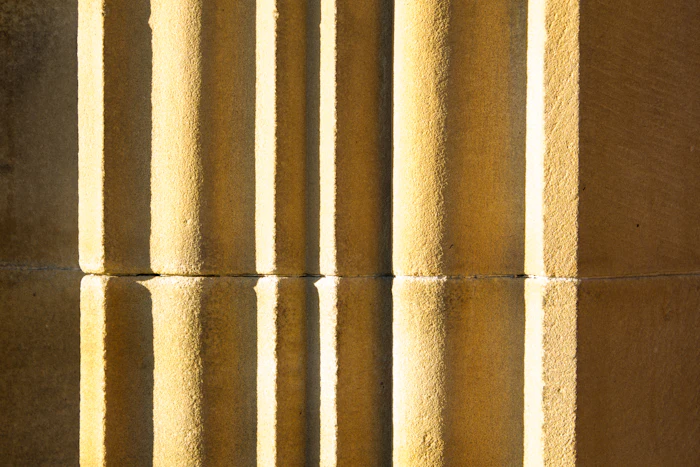 Warm light falling across fluted stone columns