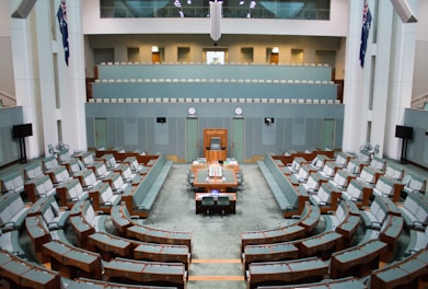 a large room with rows of chairs and a podium