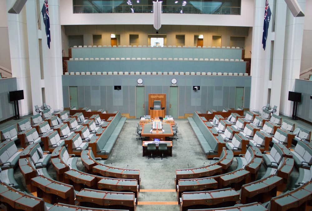a large room with rows of chairs and a podium