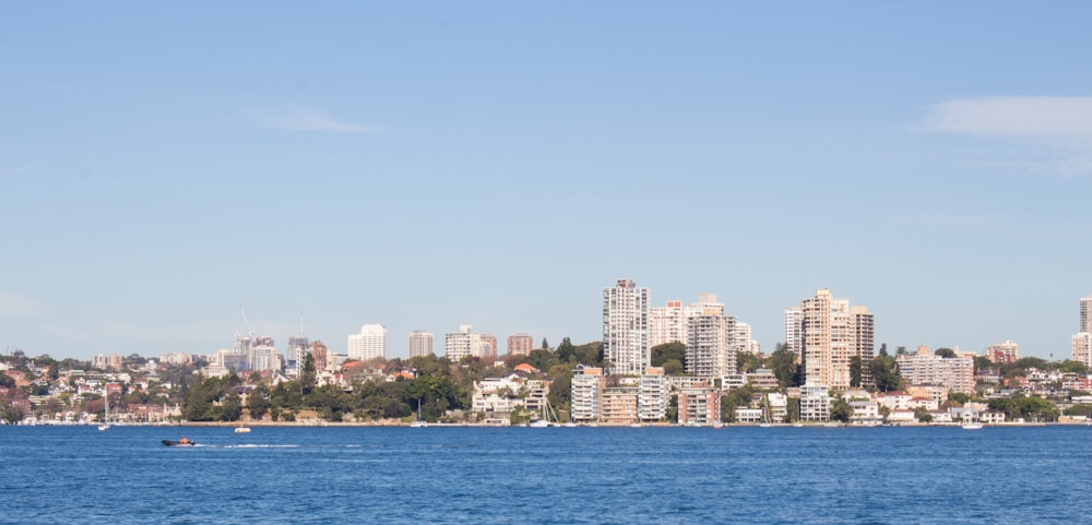 a large body of water with a city in the background