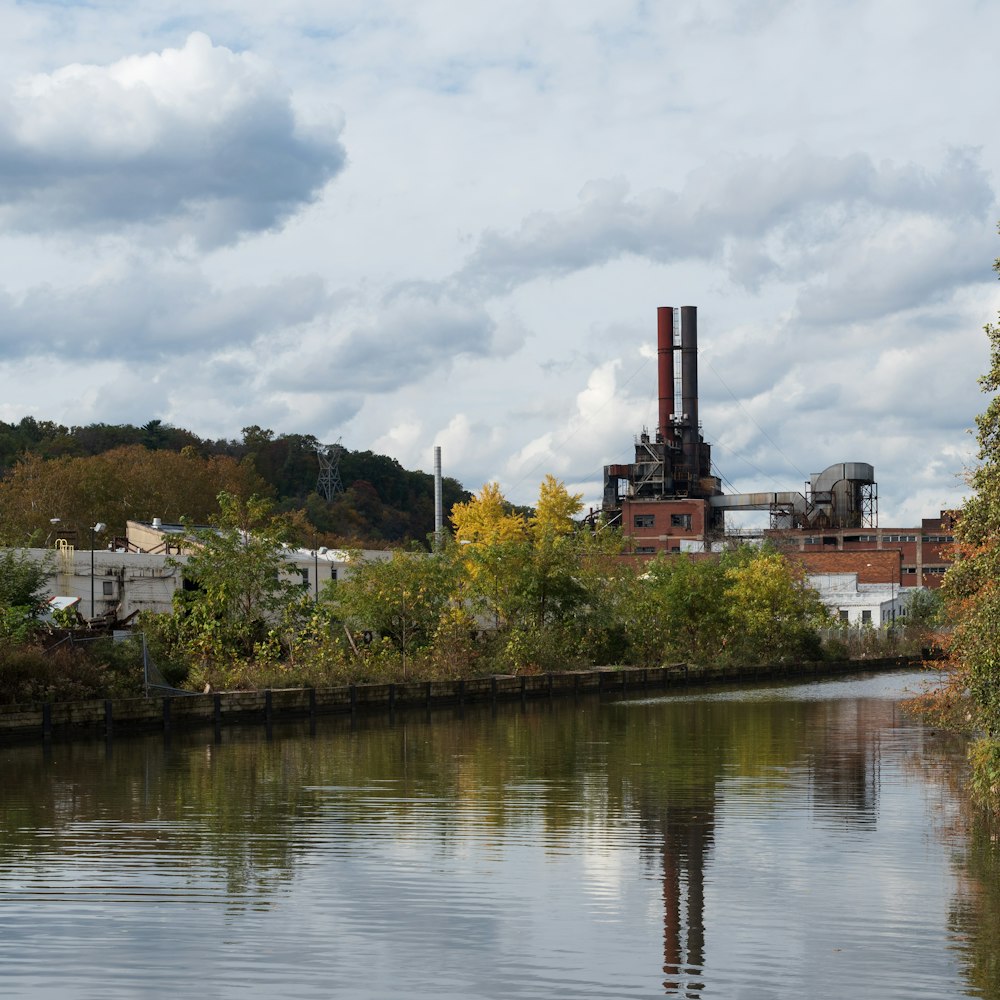 a river with a factory in the background