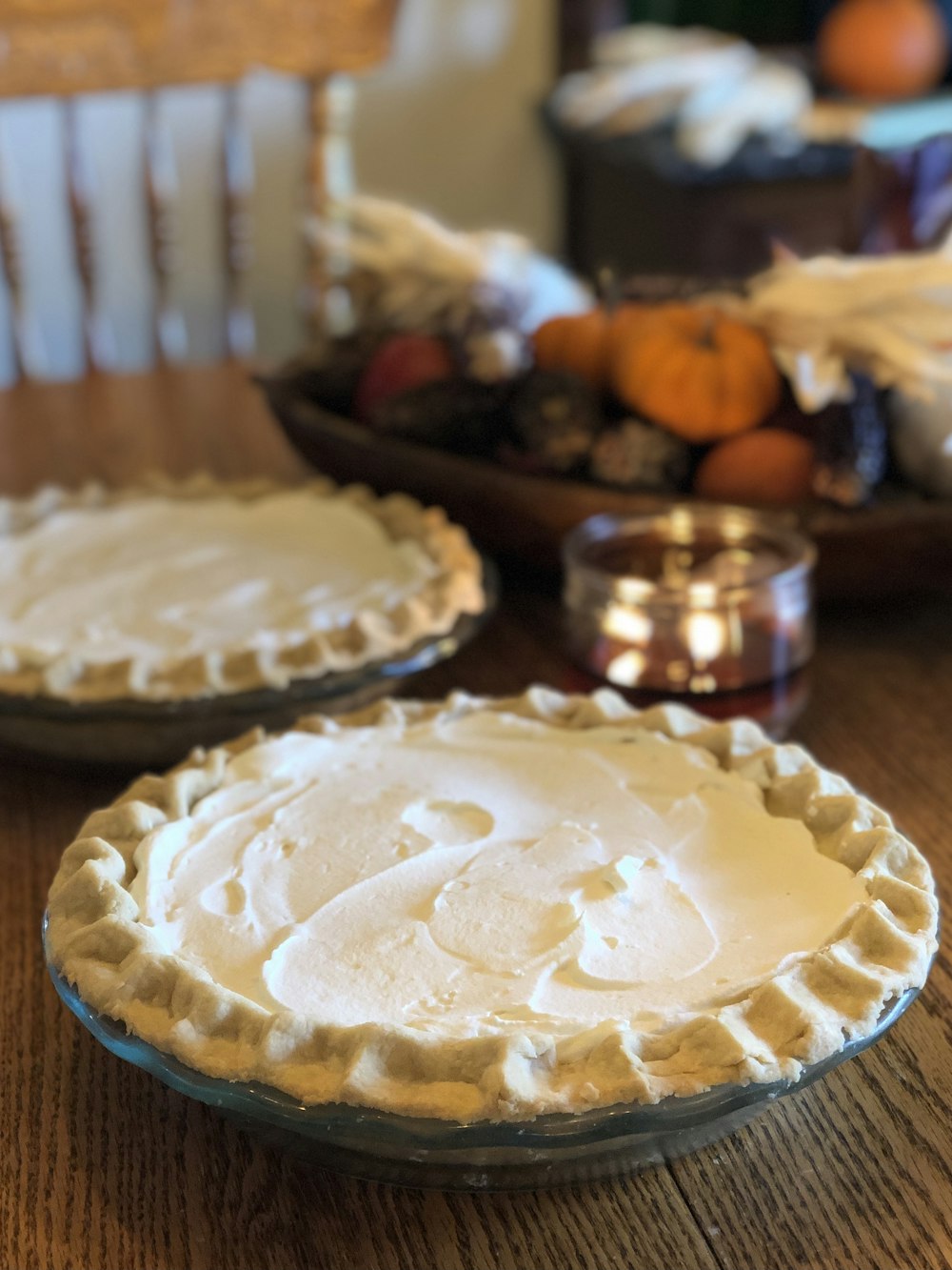two pies sitting on top of a wooden table
