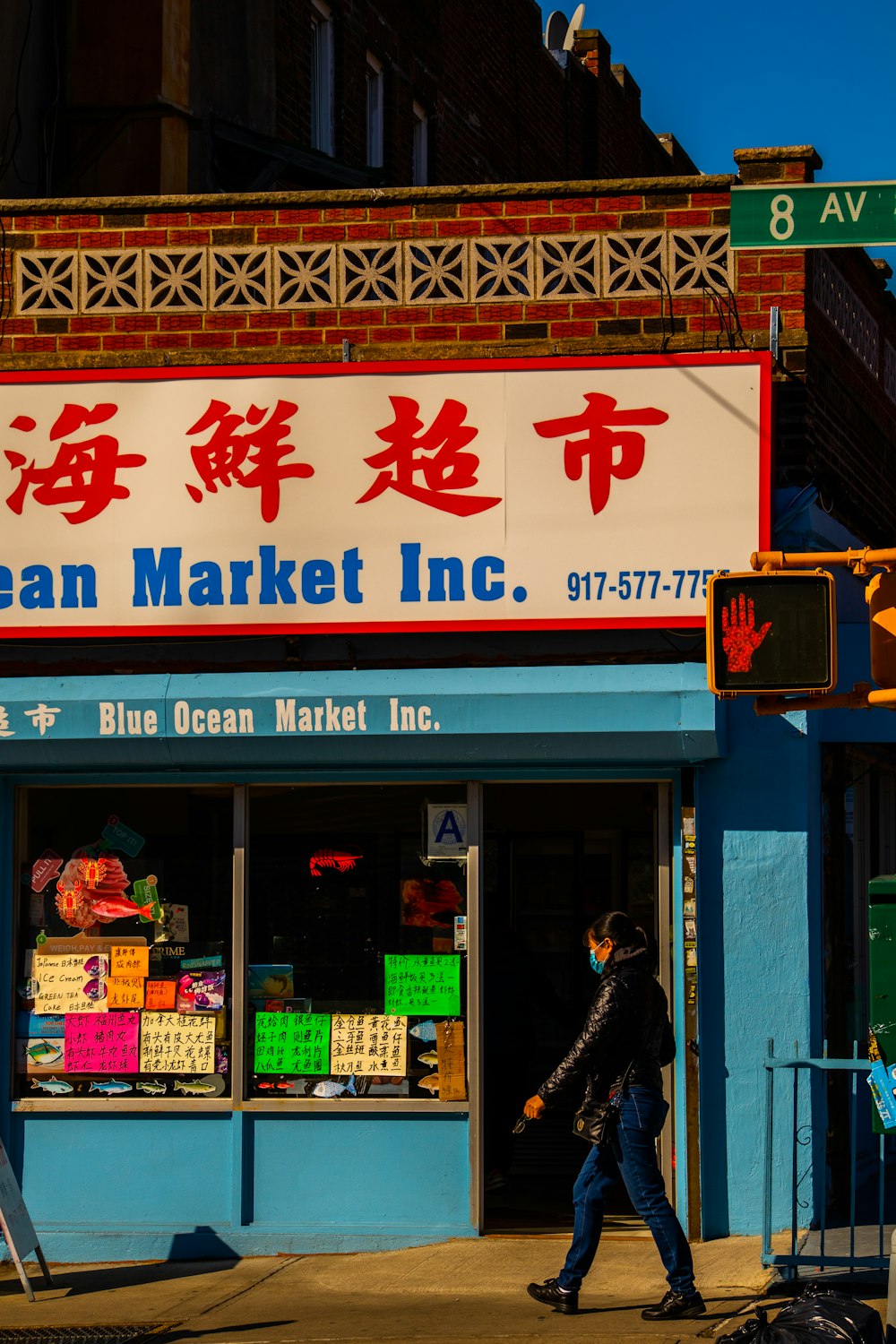 a man walking past a blue ocean market