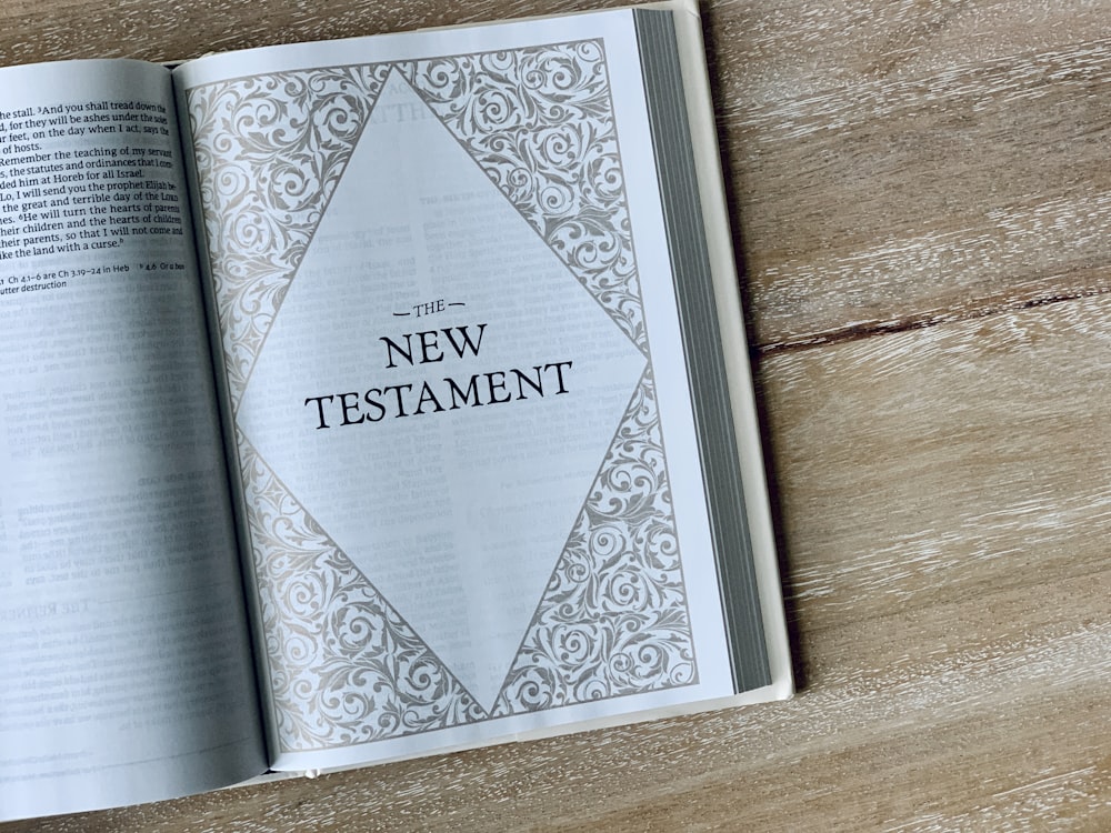 an open bible on a wooden table