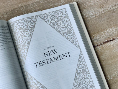 an open bible on a wooden table