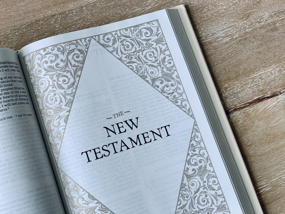 an open bible on a wooden table