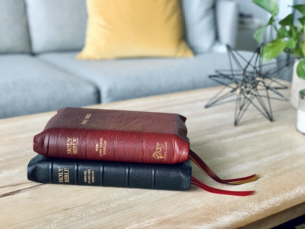 a couple of books sitting on top of a wooden table