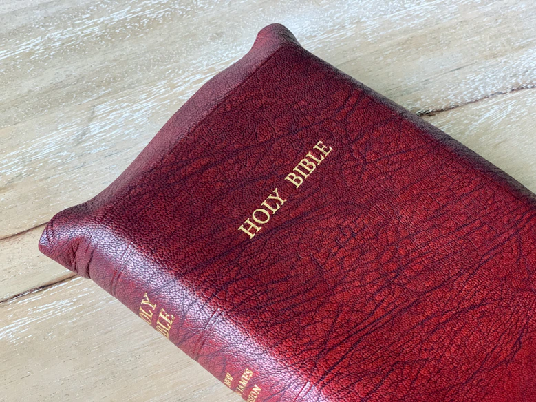 a close up of a bible on a wooden surface