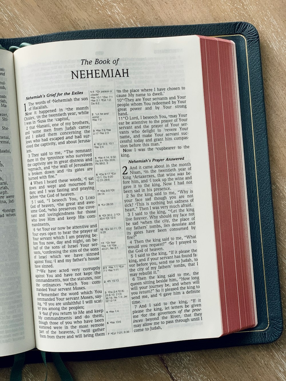 a book of nehemiah on a wooden table