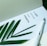 A page with a motivational quote is paired with a green plant leaf and a white fountain pen. The quote reads 'The joy of the Lord is your strength.' The setting conveys a serene and inspirational atmosphere.