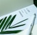 A page with a motivational quote is paired with a green plant leaf and a white fountain pen. The quote reads 'The joy of the Lord is your strength.' The setting conveys a serene and inspirational atmosphere.