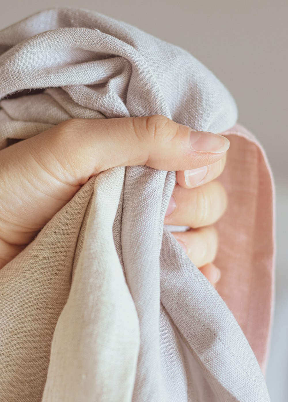 a woman's hand holding a cloth over her shoulder